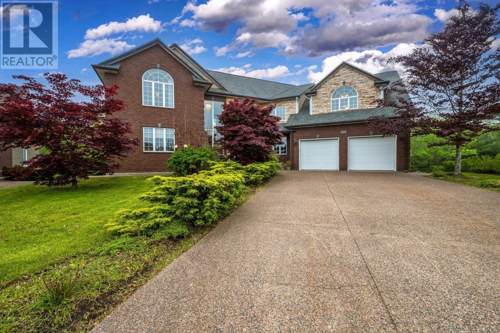 A house with a driveway and trees
AI-generated content may be incorrect.