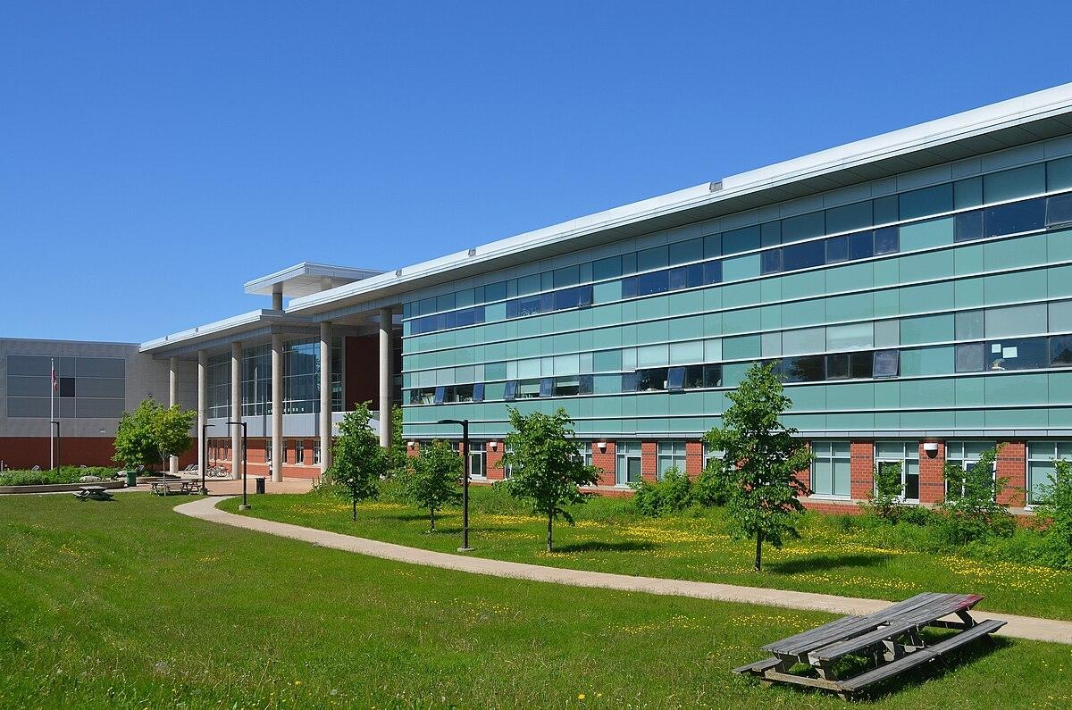 A building with a lawn and trees
AI-generated content may be incorrect.